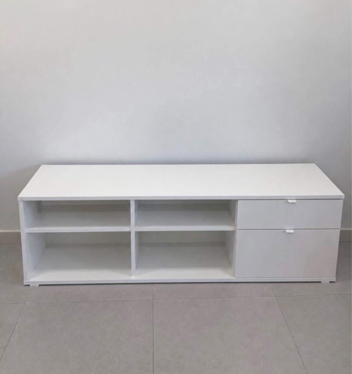 Mueble TV blanco con cajones y estantes abiertos